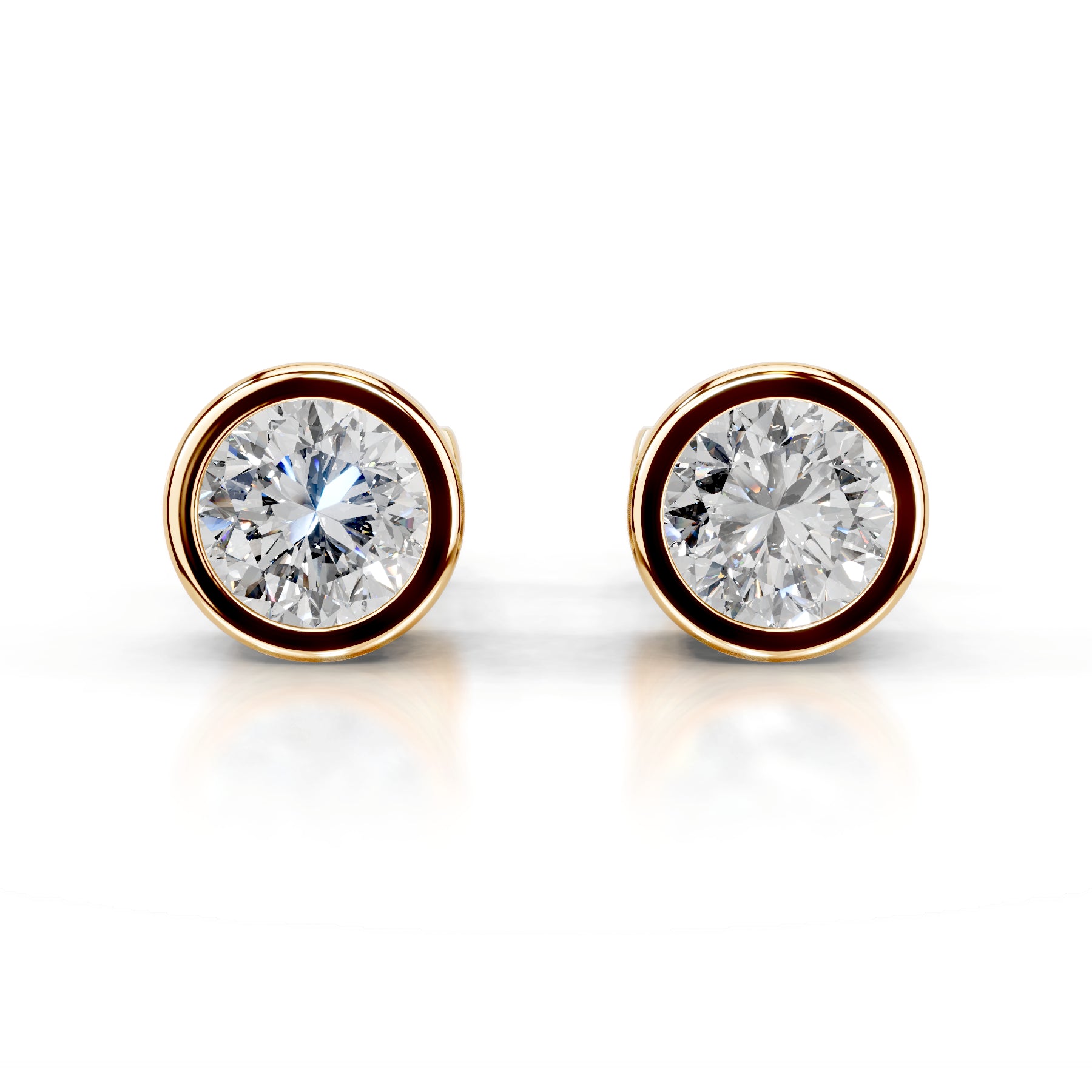 Pair of diamond stud earrings with gold rims on a white background